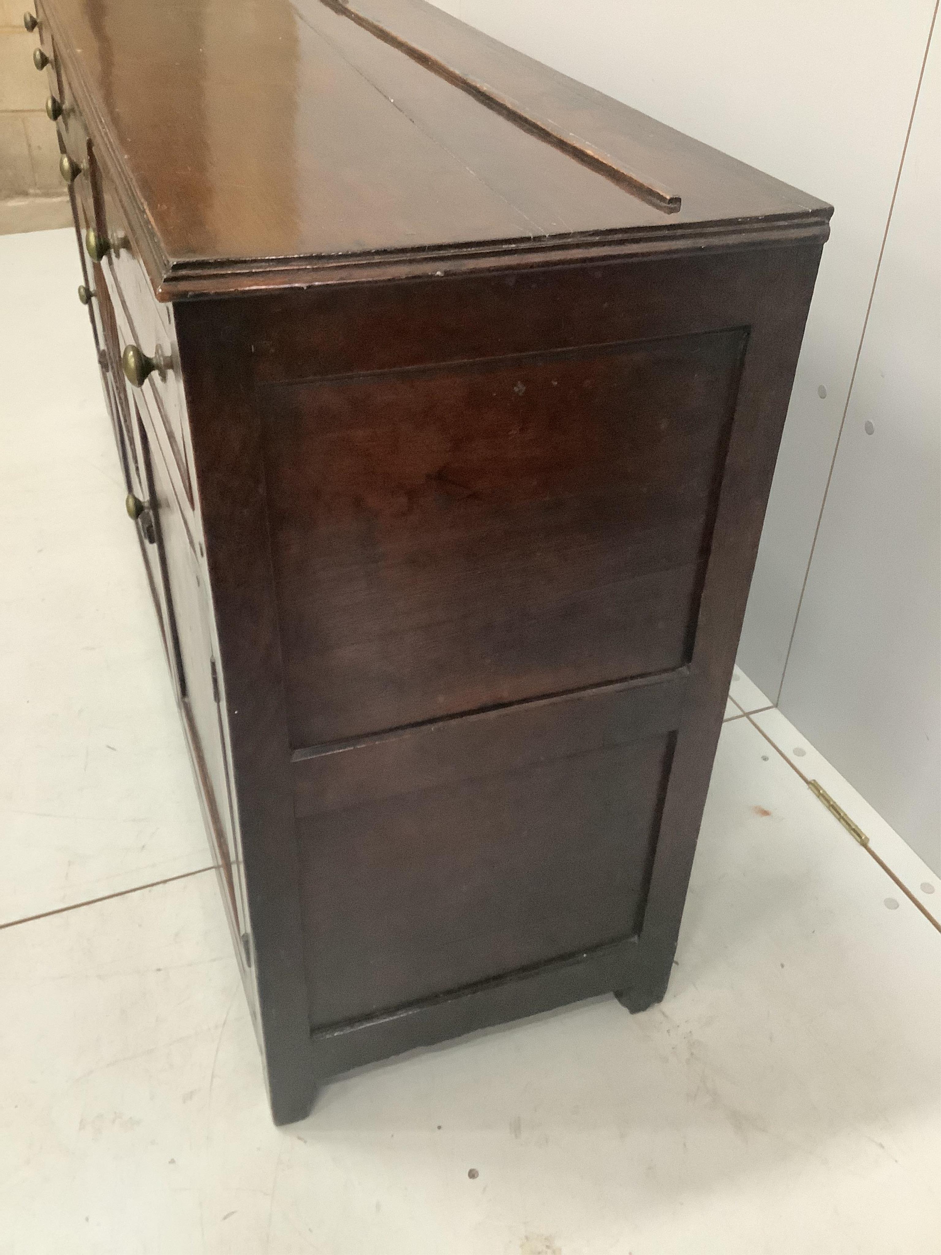 An 18th century North Wales oak enclosed dresser with central spindled glass or food compartment, width 163cm, depth 43cm, height 84cm. Condition - light wear but essentially good. Purchased from the specialist oak deale